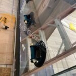 A close-up of a technician smoothing the edges of a newly installed storefront glass panel in a Washington DC property to ensure a perfect fit