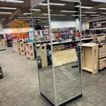 A technician installing a large mirror in a Virginia store during a commercial mirror installation project.